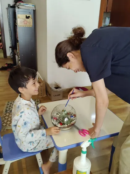 There is nothing more heartwarming than seeing a parent and child creating something together. This little one is getting some help building his very own terrarium, a perfect activity for family bonding and making memories.