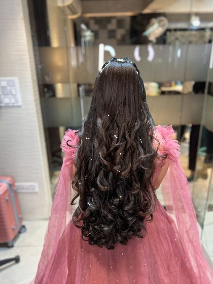 Another angle of the long, curly hairstyle, showing the beautiful drape of the hair.