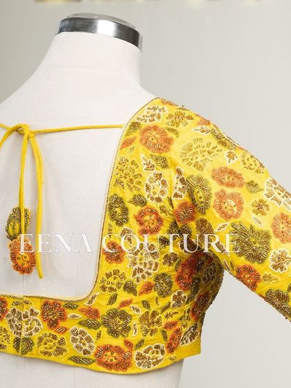 Another take on the yellow raw silk blouse, this piece features a classic Katori cut. The front is kept simple to highlight the fit, while the back and sleeves are adorned with a vibrant floral pattern in multi-colored beadwork.