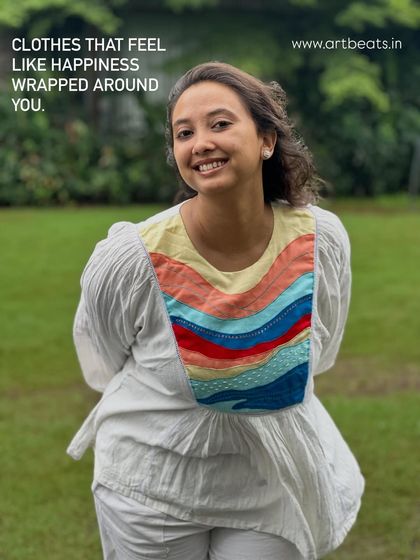 Clothes that feel like happiness wrapped around you. The Seascape frill top, with its colorful art panel, is designed to emote joy and playfulness.