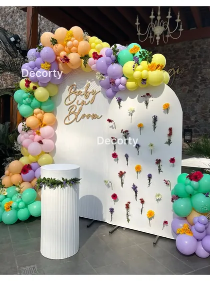 The full 'Baby in Bloom' backdrop, showing the flower wall detail and the beautiful pastel balloon arch.