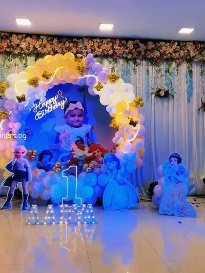 A wide view of a beautiful Disney Princess first birthday party in a hall.