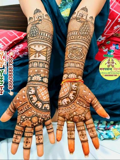 A festive design with peacocks inside palace windows and elephants marching on the wrists. This is a perfect example of a full, traditional mehndi look.