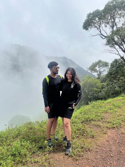 A couple enjoys the misty mountain views on the Kodachadri trek.