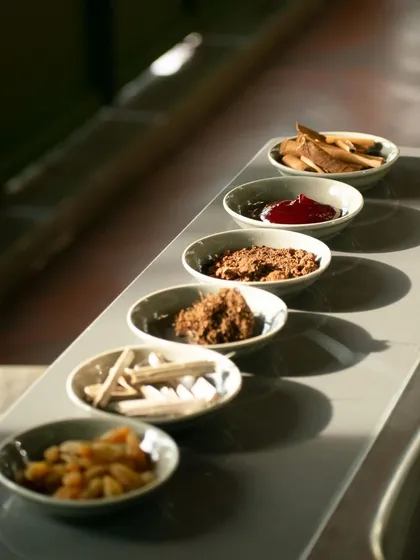 A sensory exploration kit used in our chocolate profiling workshop. Each bowl contains a different element, from cacao nibs to spices, designed to train the palate and nose to identify the complex aromas and tastes in craft chocolate.