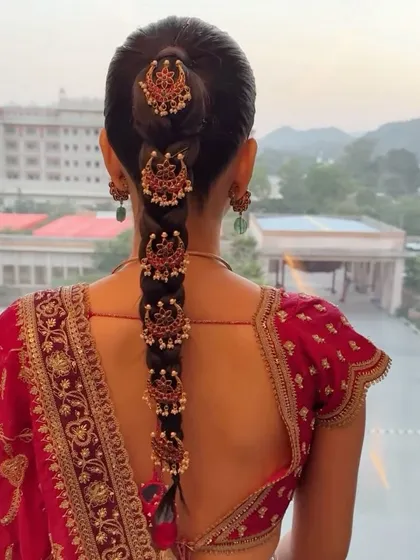 A traditional South Indian bridal braid, characterized by its neatness and the use of classic temple jewelry along its length. This is a specialized technique I teach.