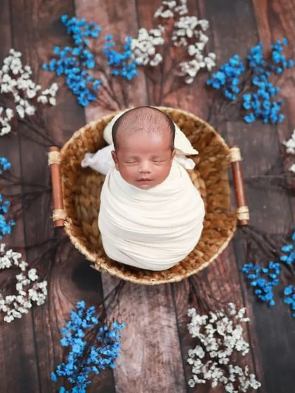 A precious baby boy surrounded by delicate flowers. Using props like this wicker basket and dried florals adds such a beautiful, rustic touch.