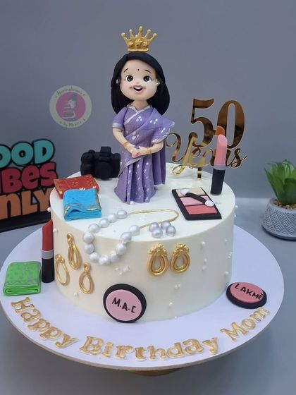 The full 50th birthday cake, with the custom figurine surrounded by her favorite things like makeup and jewelry.