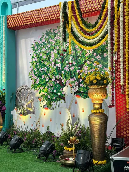 Another backdrop from our Vrindavan theme, depicting sacred cows under a blossoming tree, with garlands of fresh flowers hanging at the sides.