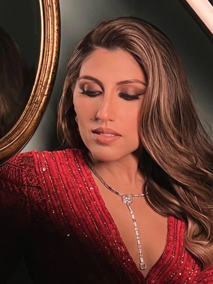 A moody, artistic shot of the bride, her wavy hair and makeup looking flawless.