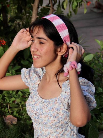 Adjusting the pink headband. It’s made with soft cotton yarn that has a bit of stretch for a perfect fit.