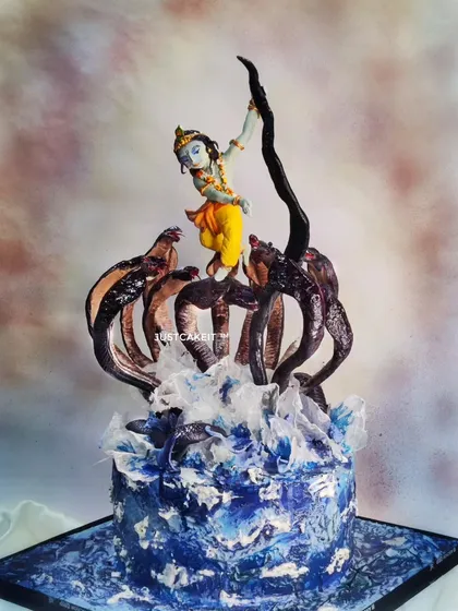 My award-winning 'Krishna dancing on Kaaliya Naag' cake is a piece of devotional art. The entire dynamic scene, including Krishna's pose and the splashing water of the Yamuna, is hand-molded and painted to capture a divine moment.