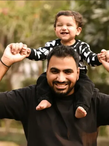 A father gives his son a happy shoulder ride during their outdoor family shoot. These joyful, candid moments are the essence of our lifestyle photography.