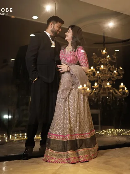 A romantic shot of the couple. The chandelier in the background adds to the glamour of their perfectly coordinated evening wear.