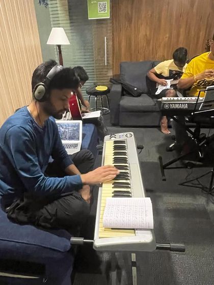 A busy session at MusiGo, with students learning keyboard and guitar in both individual and group settings.