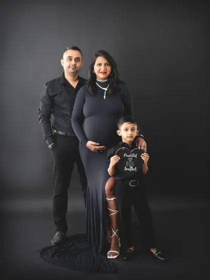 The whole family gets to share in the excitement. We love capturing these moments, like a big brother getting ready for his new role. Our studio can create these classic, dramatic family portraits that feel both modern and timeless.