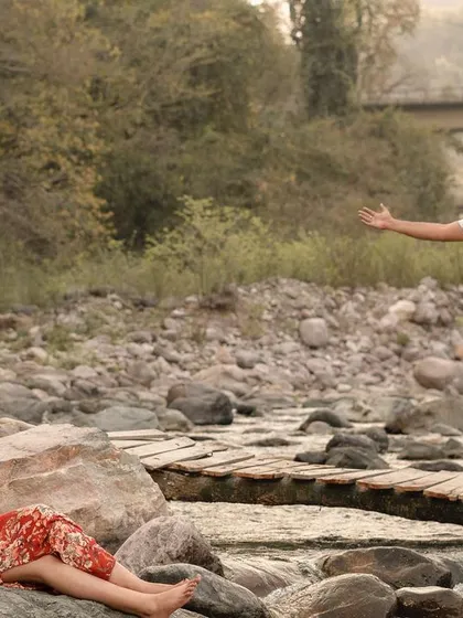 A candid and joyful moment from a pre-wedding shoot by the river in Rishikesh.