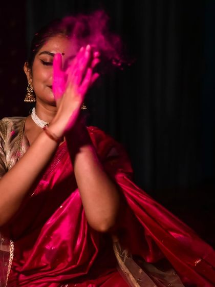 The act of playing with colors, captured in a moment of blissful abandon. This image is part of a creative photoshoot celebrating the spirit of Holi.