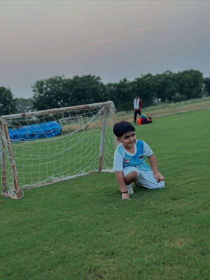 The joy of being on the field. One of our youngest members celebrating near the goal post during a fun training session.