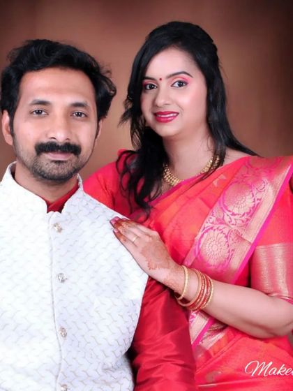 A classic studio portrait of a couple. The client's makeup is clean and polished, enhancing her natural beauty for this special occasion photoshoot.