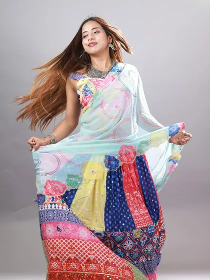 This shot captures the beautiful twirl of the multi-colored Garba lehenga. The studio fan and the model's movement bring the image to life.