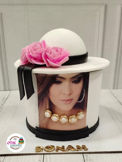 A unique and personal cake featuring an edible photo print. We can turn any photo into a sweet centerpiece, like this one designed to look like a stylish hat.