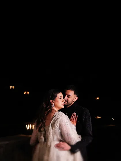 A romantic embrace under the stars. This night-time shot uses the darkness to create an intimate and dramatic portrait of the couple.