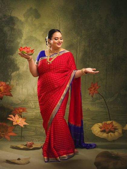 The mother-to-be stands gracefully in a painted lotus pond, holding a lotus flower. This image symbolizes purity, beauty, and the miracle of new life.