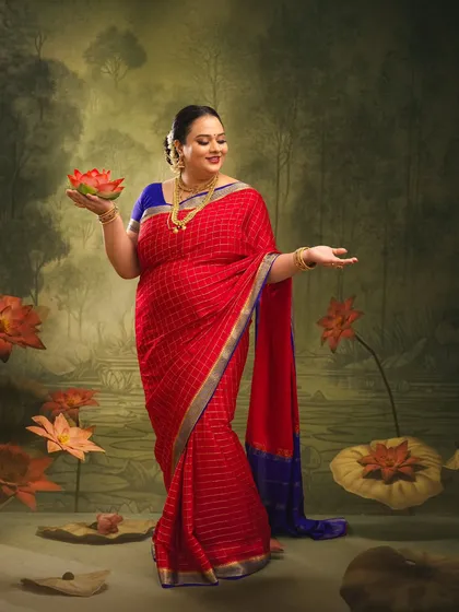 The mother-to-be stands gracefully in a painted lotus pond, holding a lotus flower. This image symbolizes purity, beauty, and the miracle of new life.