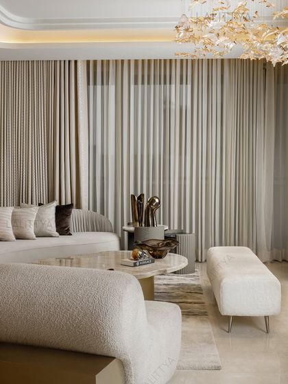 A moment worth pausing for. This living area is designed to welcome, to soften, to stay. The layers of neutral fabrics, metallic accents, and soft lighting create a serene and inviting atmosphere.