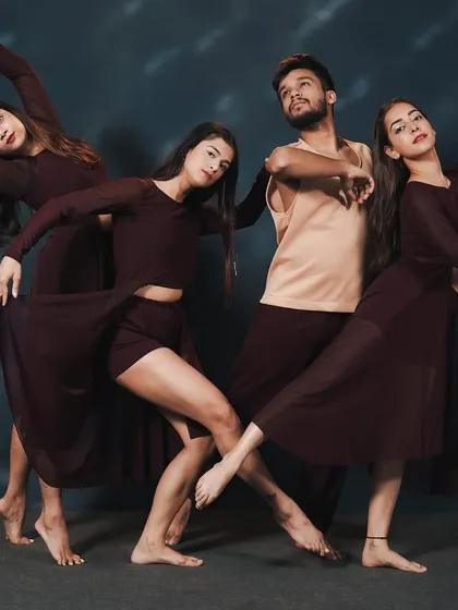 The 'NEXUS' performers in a complex, interconnected pose, demonstrating the high level of skill and artistry our dancers achieve.