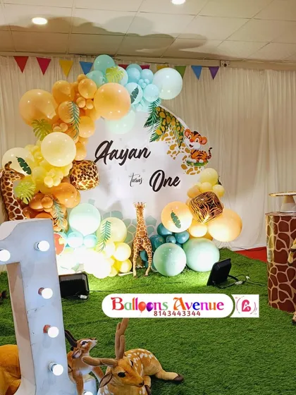 Another angle of Aayan's jungle party, showing the large light-up number '1' and the artificial grass flooring that adds to the safari feel.