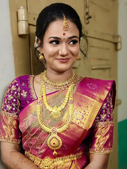 A beautiful engagement makeover with a magenta Kanjivaram saree and traditional gold jewelry.