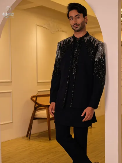 This full-length view showcases our black Jodhpuri jacket with cascading silver and black sequin work. Paired with a black kurta and trousers, it creates a sleek, modern, and glamorous look.