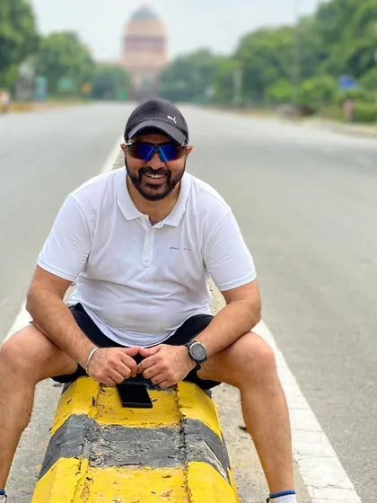 Taking a quick break on a road divider with India Gate in the distance. We always find unique photo opportunities during our city runs.