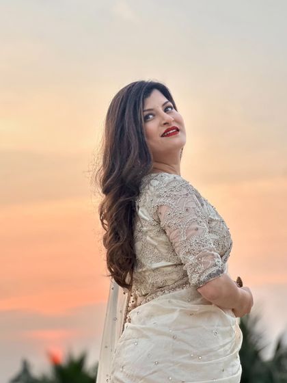 Another beautiful shot against the evening sky. The warm colors of the sunset create a beautiful backdrop for her elegant look.
