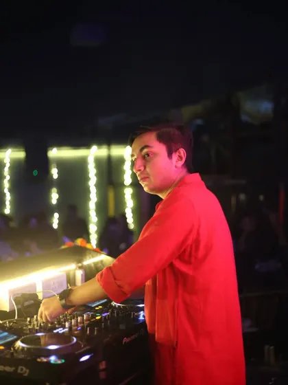 A close-up shot showing my concentration while mixing tracks in a club setting.