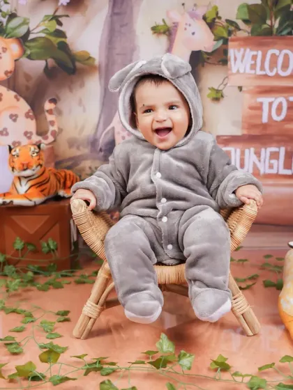 Dressed in a cute animal onesie, this baby is all smiles. The jungle theme is perfect for adventurous little explorers.