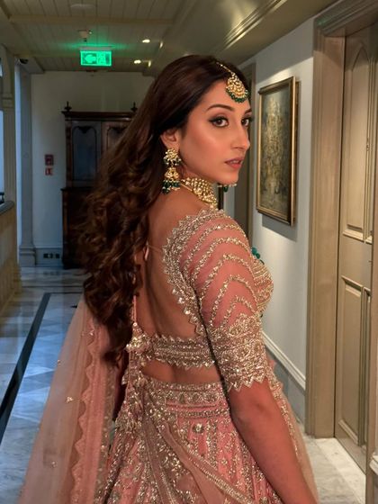 This back profile shows off the detailed blouse and elegant hairstyle, completing this regal wedding guest look.