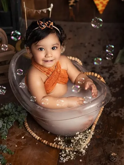 A sweet, happy smile from the tub. Bath sessions are always a hit with babies, and the warm water and playful bubbles keep them content and cheerful.