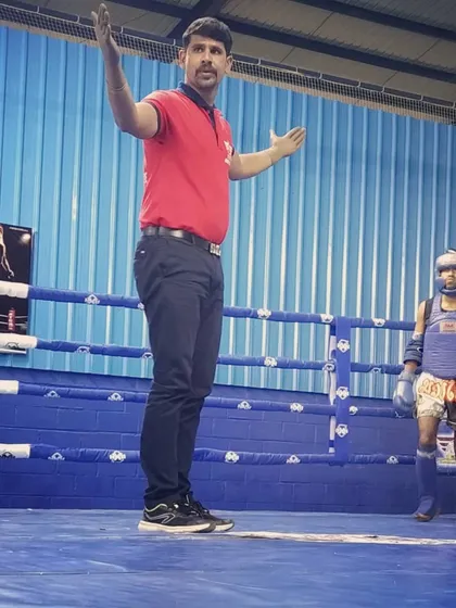Officiating a match between two young Muay Thai fighters. My role as a referee is to ensure a fair and safe contest for both competitors.