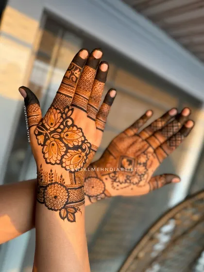 An angled shot of the stylish designer henna, showing the contrast between the two hands.