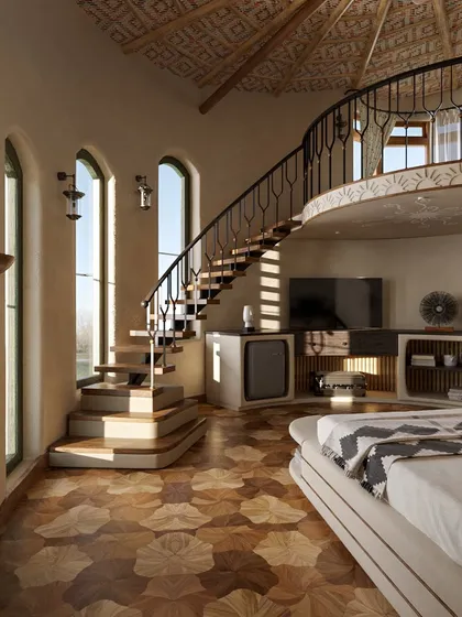 Inside the guest suites, I created multi-level spaces to add dimension and surprise. This duplex room features a gracefully curving staircase and intricate wooden flooring, with large arched windows that flood the room with natural light and connect guests to the views outside.