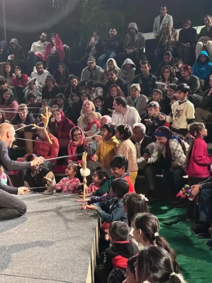 An interactive moment from 'Theatre in the Pocket', where the puppeteers bring their marionettes right into the audience, creating a personal and unforgettable experience for children and adults alike.