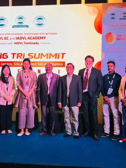 A group photograph with fellow faculty and organizers on stage at the SIG TRI Summit in Chennai. Collaborative events like these are vital for pushing the boundaries of aesthetic dermatology.