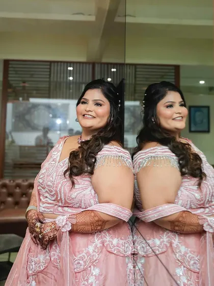A creative shot with a mirror reflection, showing the bride's profile and her beautiful smile.