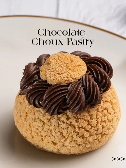 Our Chocolate Choux Pastry, featuring a crisp craquelin shell filled with a decadent chocolate cream. It's a perfect bite of texture and rich flavour, a must-try for any pastry lover.