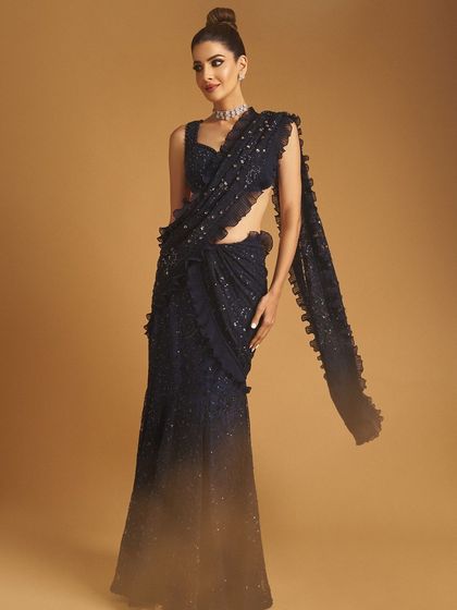 A full-length shot of the client, the saree draping beautifully and her makeup looking flawless.