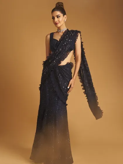 A full-length shot of the client, the saree draping beautifully and her makeup looking flawless.