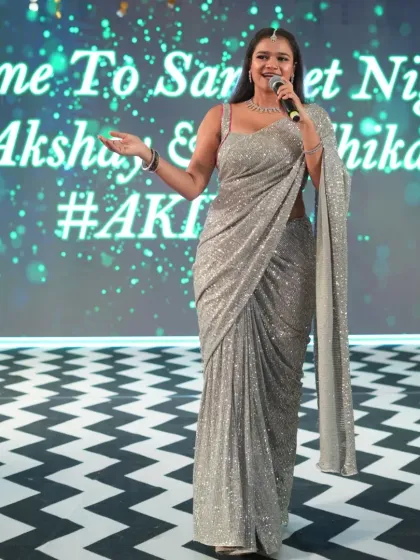 A close-up of me hosting the Sangeet, showing the details of my outfit and makeup.